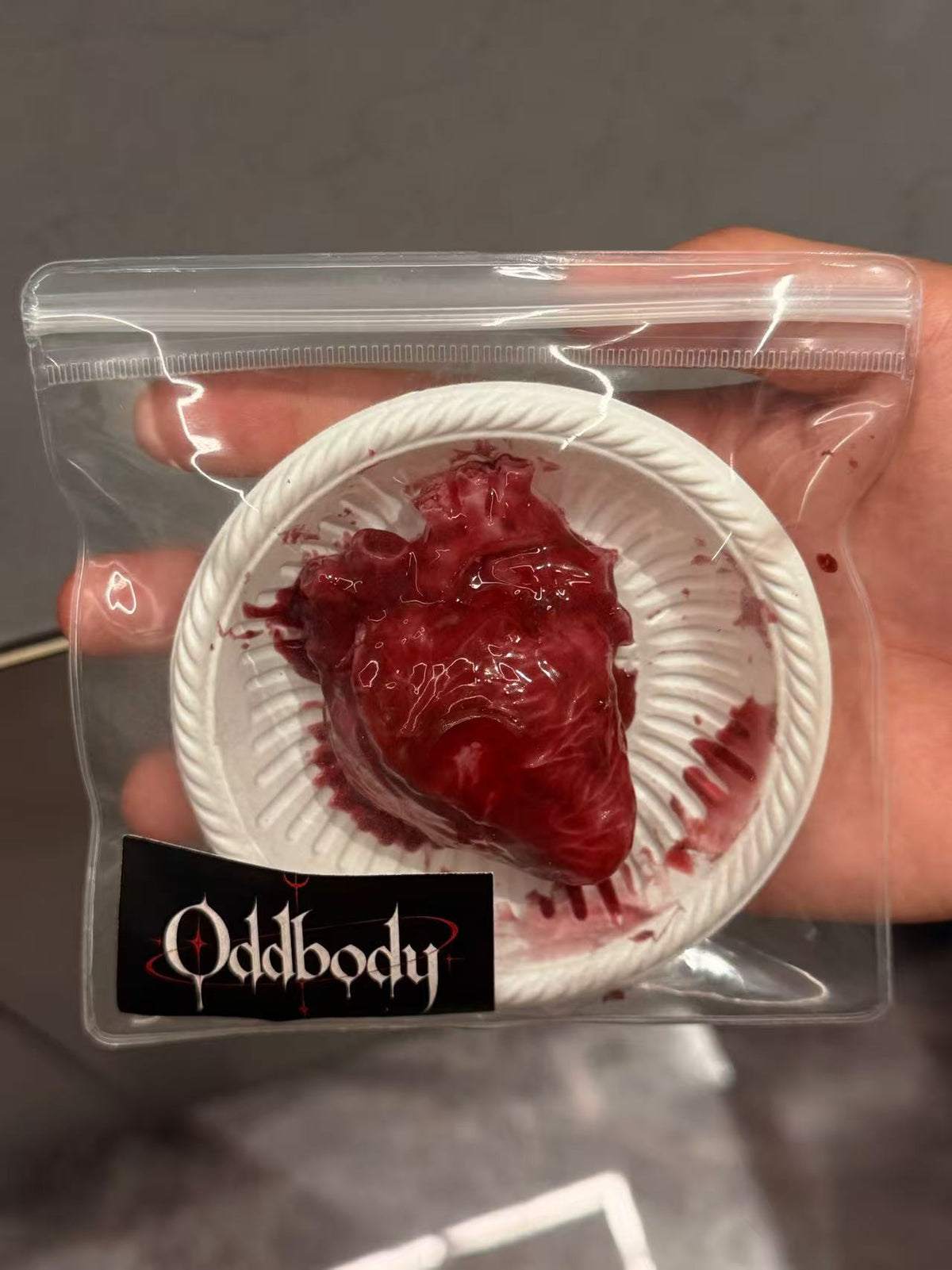 Realistic anatomical heart squishy on white plate